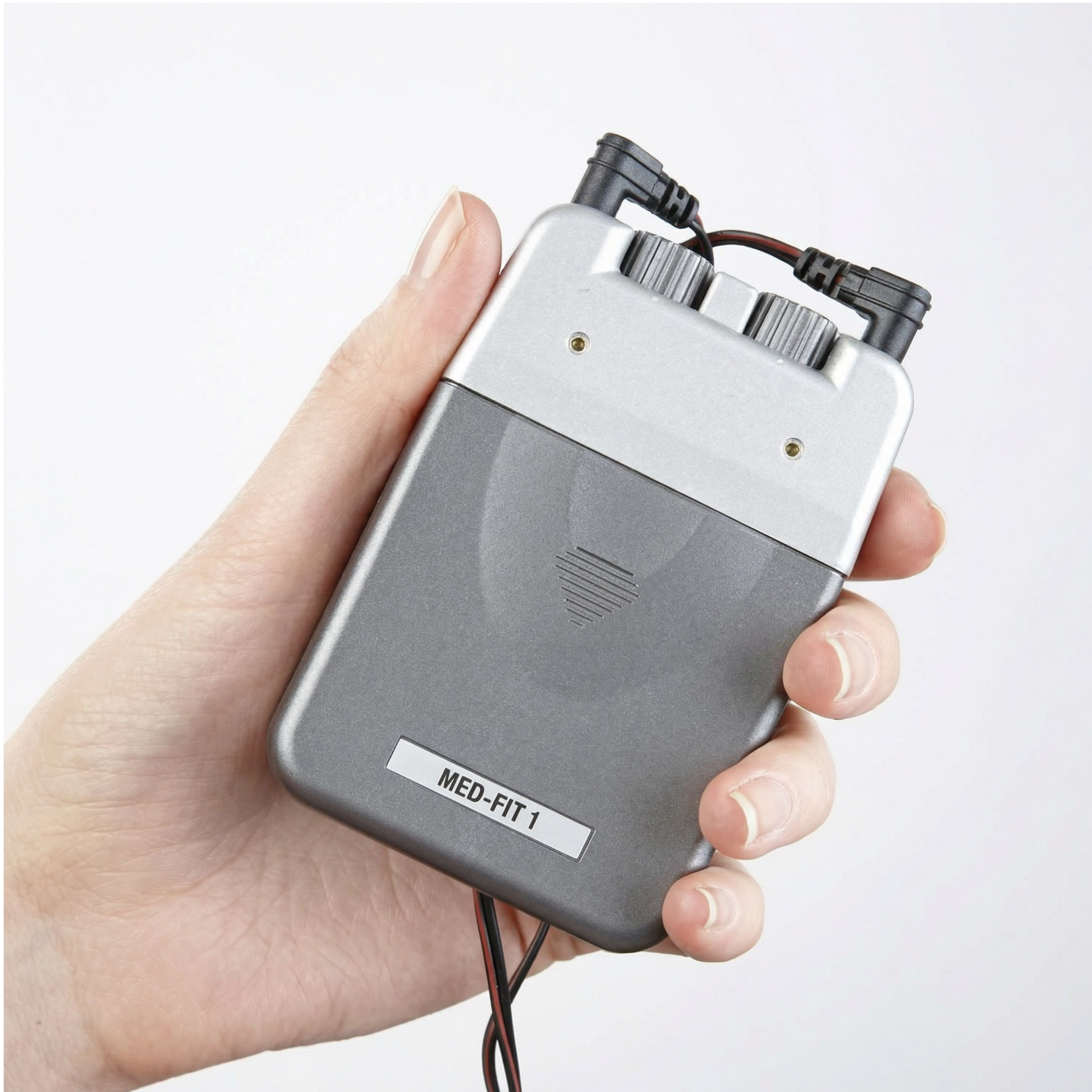 Hand holding a MED-FIT 1 device against a white background